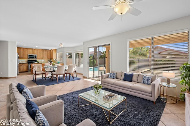 living room featuring ceiling fan and light tile patterned floors