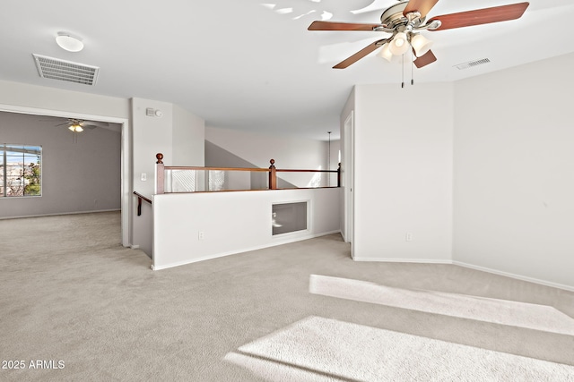 carpeted empty room featuring ceiling fan