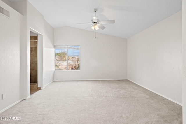 carpeted spare room featuring ceiling fan and vaulted ceiling