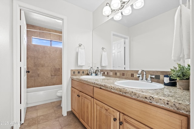 full bathroom with tile patterned flooring, tasteful backsplash, toilet,  shower combination, and vanity