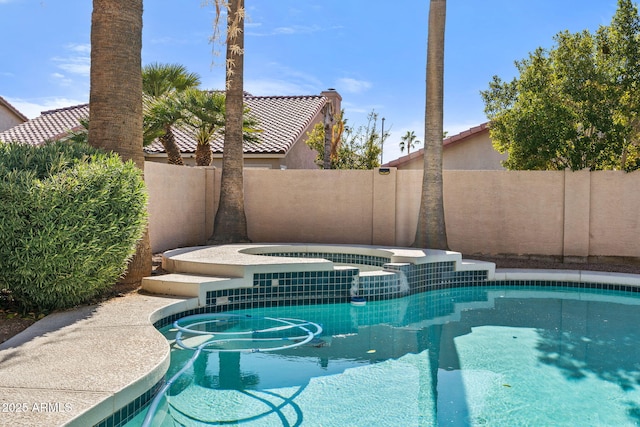 view of swimming pool featuring an in ground hot tub