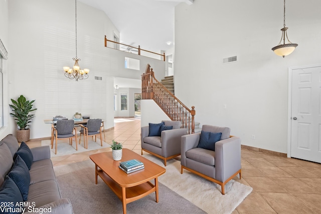 tiled living room with high vaulted ceiling and a chandelier