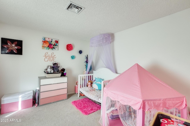 carpeted bedroom with visible vents and a textured ceiling