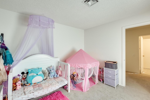 carpeted bedroom featuring visible vents and a textured ceiling