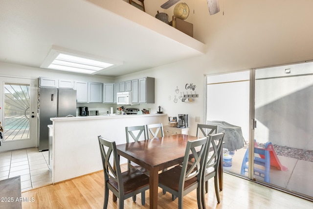 dining space featuring light wood-style floors