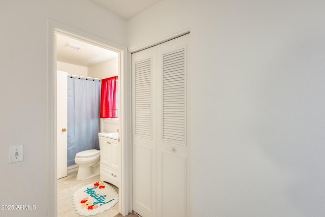 bathroom featuring visible vents, toilet, a closet, tile patterned flooring, and vanity