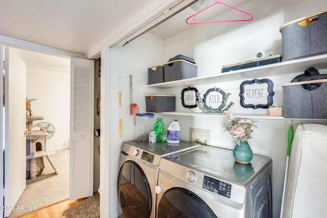 clothes washing area with separate washer and dryer and laundry area