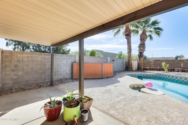 view of patio / terrace with a fenced backyard and a hot tub