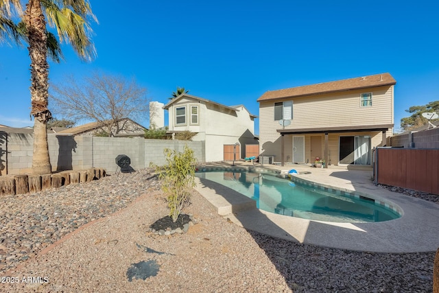 view of swimming pool with a fenced in pool, a fenced backyard, and a patio area