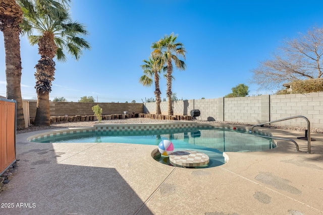 view of swimming pool with a patio area, a fenced in pool, and a fenced backyard