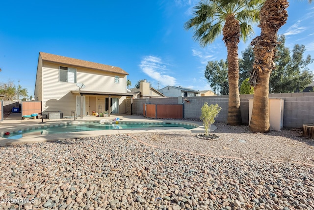 back of property featuring a patio area, a fenced backyard, and a fenced in pool