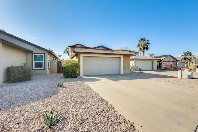 single story home with stucco siding, a garage, and driveway