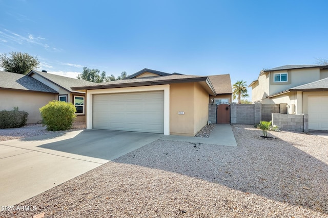 single story home featuring an attached garage, a gate, driveway, and stucco siding