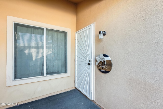 entrance to property with stucco siding