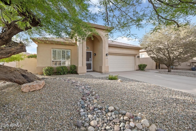 4462 E Dale Ln, Cave Creek, AZ 85331 - mediterranean / spanish-style home with a garage, stucco siding, concrete driveway, and a tile roof