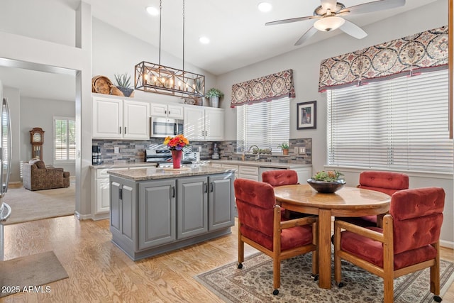 4462 E Dale Ln, Cave Creek, AZ 85331 - kitchen with stainless steel appliances, gray cabinetry, white cabinetry, ceiling fan, and light wood finished floors