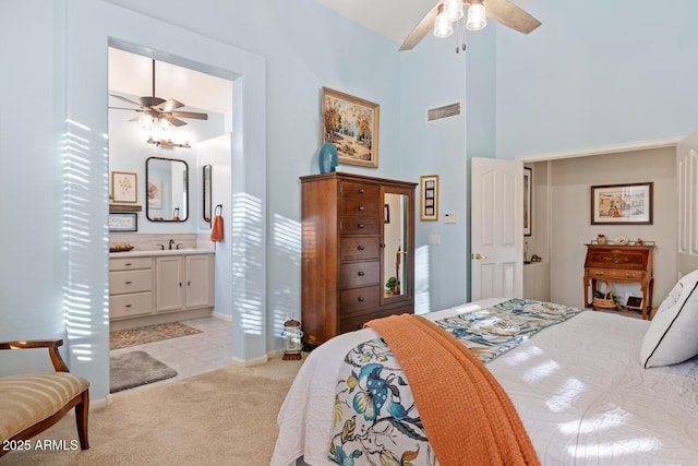 4462 E Dale Ln, Cave Creek, AZ 85331 - bedroom featuring a high ceiling, light carpet, a sink, ensuite bath, and baseboards