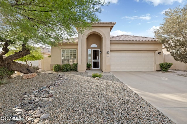 4462 E Dale Ln, Cave Creek, AZ 85331 - mediterranean / spanish house featuring an attached garage, stucco siding, and driveway
