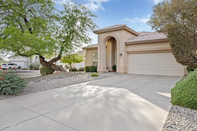 4462 E Dale Ln, Cave Creek, AZ 85331 - mediterranean / spanish-style home featuring stucco siding, an attached garage, concrete driveway, and a tile roof