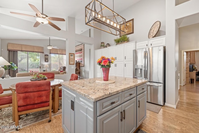 4462 E Dale Ln, Cave Creek, AZ 85331 - kitchen with stainless steel fridge, gray cabinets, open floor plan, ceiling fan, and white cabinets