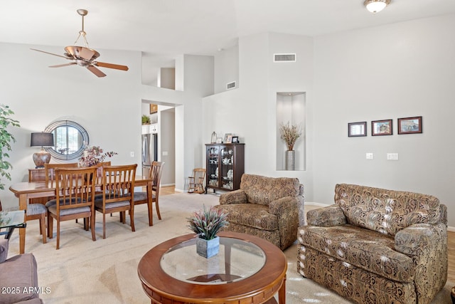 4462 E Dale Ln, Cave Creek, AZ 85331 - living room featuring ceiling fan, a towering ceiling, light colored carpet, and baseboards
