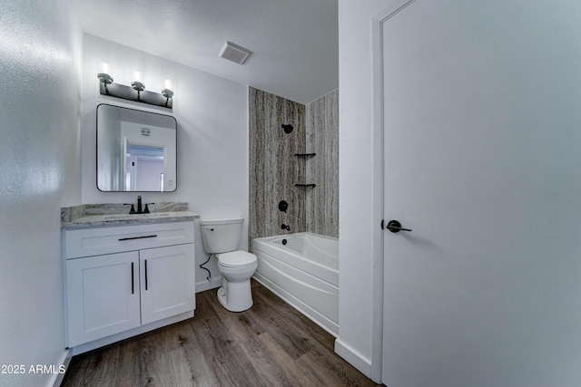full bathroom featuring toilet, wood finished floors, shower / bath combination, and vanity
