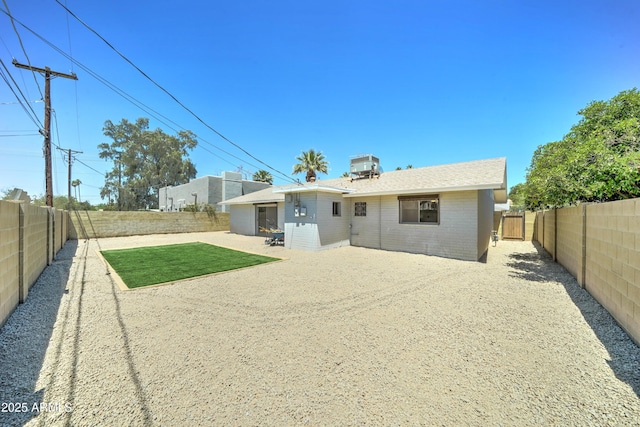back of house featuring a fenced backyard, central AC unit, a patio area, and brick siding