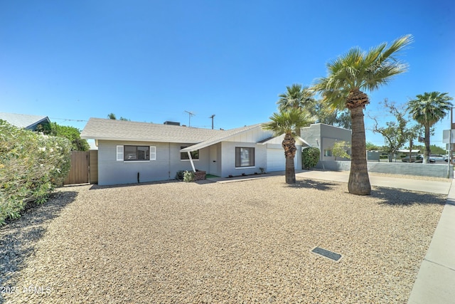 view of front of property with fence and an attached garage