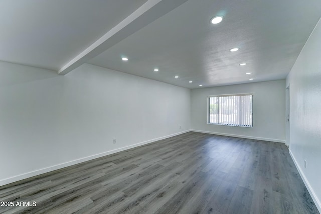 unfurnished room featuring recessed lighting, wood finished floors, and baseboards