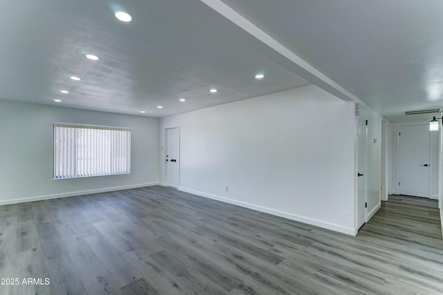 unfurnished living room with recessed lighting, wood finished floors, and baseboards