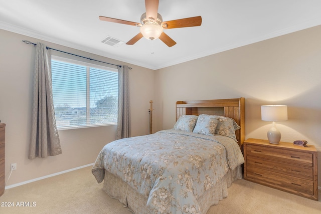 carpeted bedroom with ceiling fan and crown molding