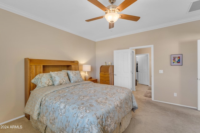 carpeted bedroom featuring ceiling fan and ornamental molding