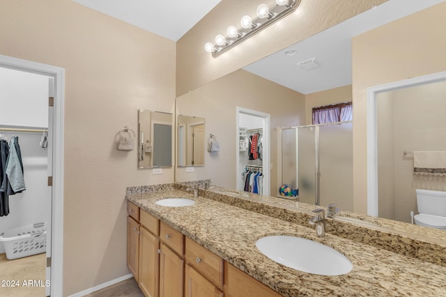 bathroom with a shower with door and vanity