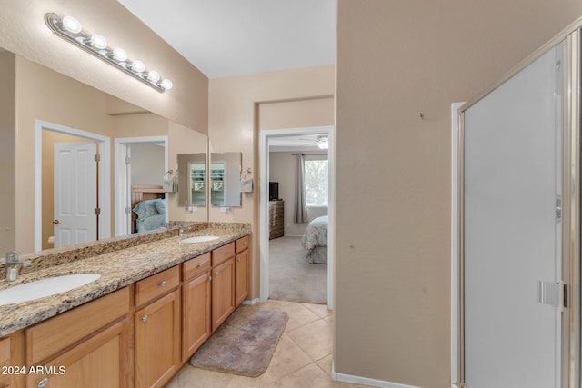 bathroom featuring tile patterned flooring, vanity, ceiling fan, and a shower with shower door