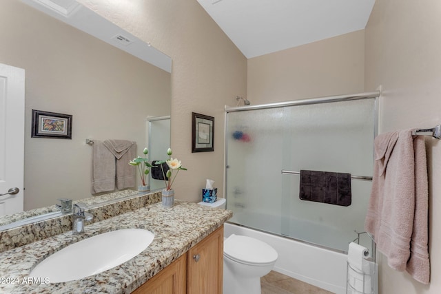 full bathroom with shower / bath combination with glass door, tile patterned floors, vanity, and toilet