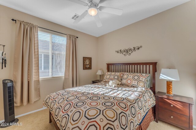 bedroom with ceiling fan and light carpet