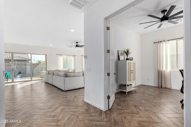 living room with light parquet flooring and ceiling fan