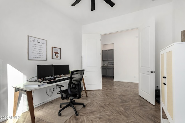 office area with dark parquet flooring and ceiling fan