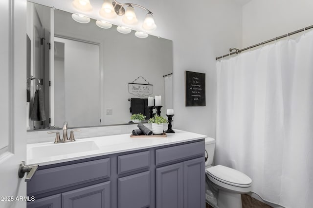 bathroom featuring vanity and toilet