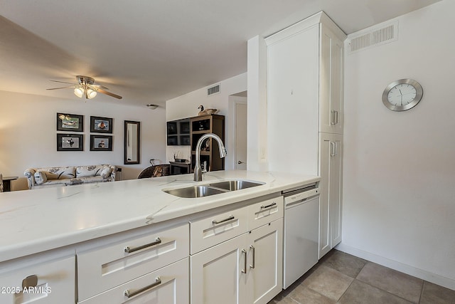 kitchen featuring dishwasher, ceiling fan, visible vents, and a sink