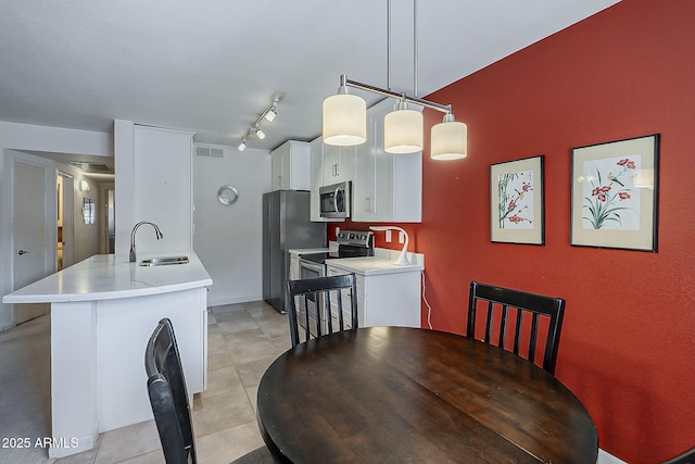 dining area featuring light tile patterned floors, visible vents, and track lighting