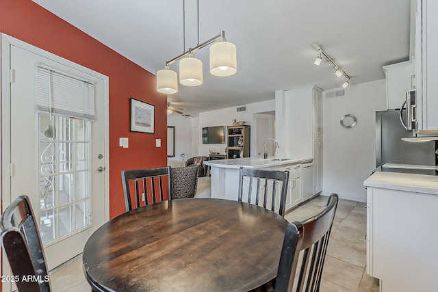 dining space featuring light tile patterned floors, visible vents, and rail lighting