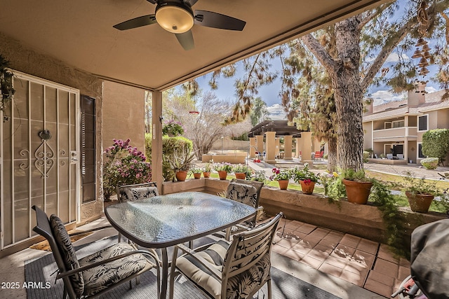 view of patio featuring outdoor dining space and a ceiling fan