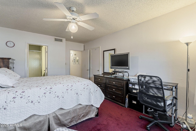 bedroom with visible vents, a textured ceiling, dark carpet, and a ceiling fan