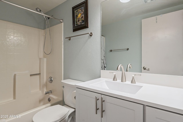 full bath with toilet, vanity,  shower combination, and a textured wall