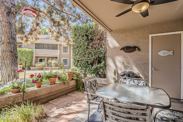 view of patio with grilling area, outdoor dining space, and a ceiling fan