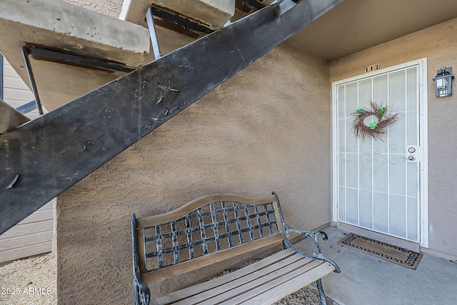 property entrance with stucco siding