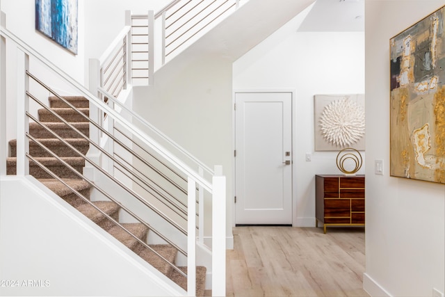 stairway featuring wood-type flooring