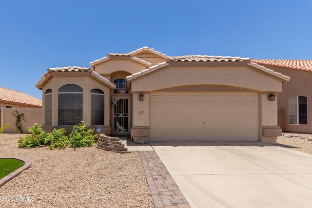 9559 W Runion Dr, Peoria, AZ 85382 - mediterranean / spanish-style house featuring a garage, stucco siding, and concrete driveway