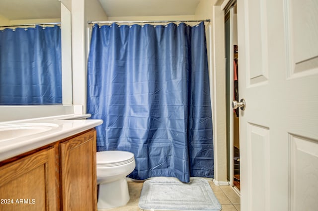 bathroom featuring vanity, toilet, curtained shower, and tile patterned flooring